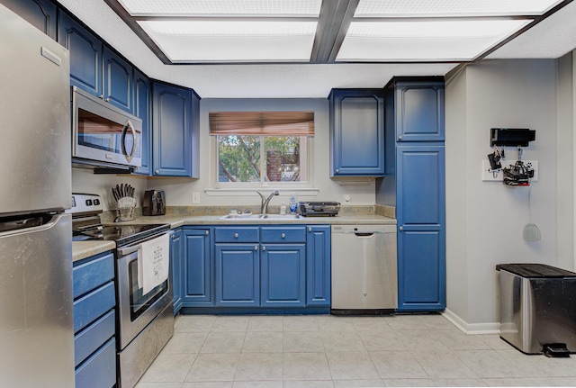 4764 Eagle Crest Dr Unit 4002, Memphis, TN 38117 - kitchen featuring stainless steel appliances, blue cabinetry, light countertops, and light tile patterned floors