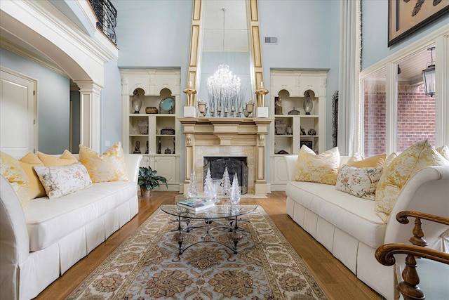 269 N Monterey Farms Cv, Collierville, TN 38017 - living room with a premium fireplace, wood finished floors, and a towering ceiling