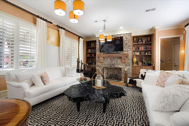 269 N Monterey Farms Cv, Collierville, TN 38017 - living room featuring a stone fireplace, crown molding, and built in features