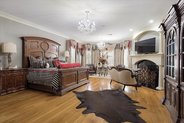 269 N Monterey Farms Cv, Collierville, TN 38017 - bedroom featuring a chandelier, light wood-style flooring, crown molding, a fireplace, and recessed lighting