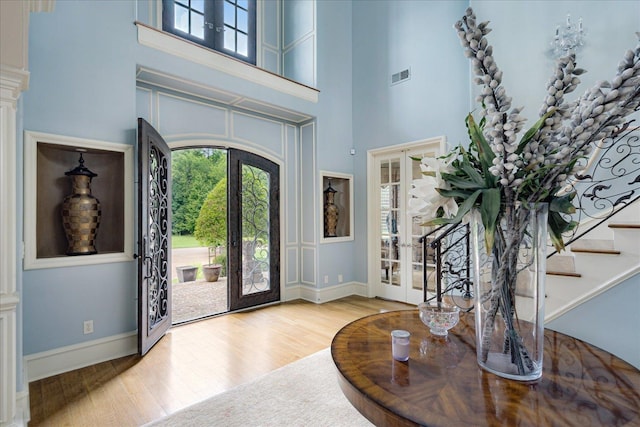 269 N Monterey Farms Cv, Collierville, TN 38017 - entryway with french doors, a towering ceiling, wood finished floors, and plenty of natural light