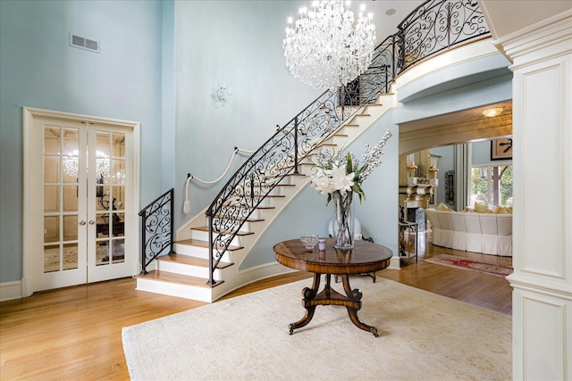 269 N Monterey Farms Cv, Collierville, TN 38017 - foyer entrance with a high ceiling, french doors, wood finished floors, stairs, and a chandelier
