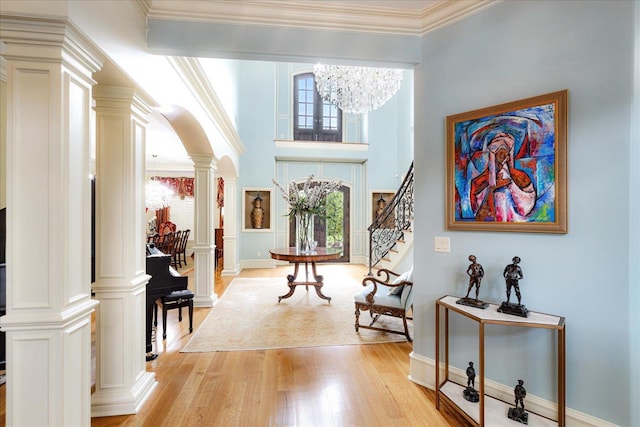 269 N Monterey Farms Cv, Collierville, TN 38017 - entryway with ornate columns, light wood-type flooring, arched walkways, a chandelier, and stairs