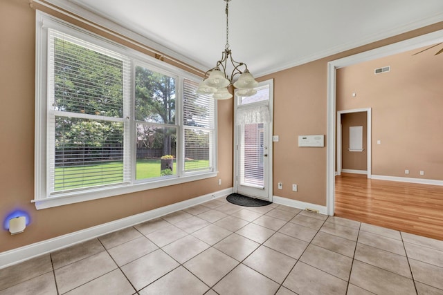 1062 Center Ridge Rd, Collierville, TN 38017 - unfurnished dining area featuring a chandelier, light tile patterned floors, and crown molding