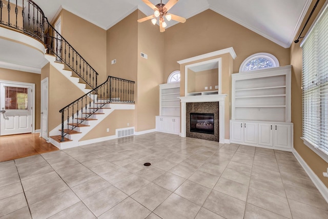 1062 Center Ridge Rd, Collierville, TN 38017 - unfurnished living room with ceiling fan, stairway, a fireplace, tile patterned floors, and plenty of natural light