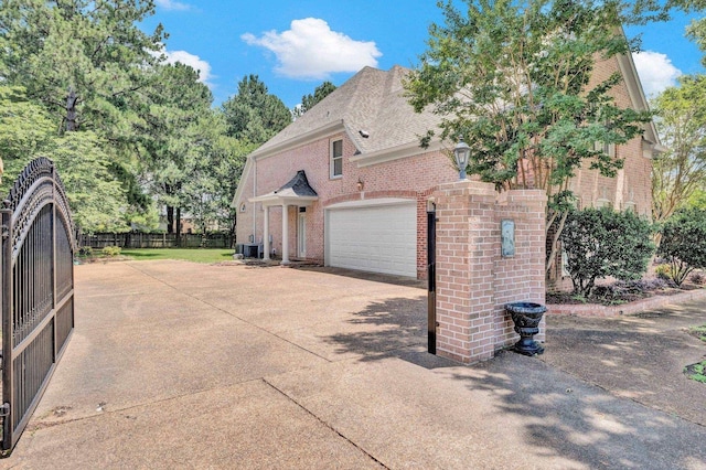 1062 Center Ridge Rd, Collierville, TN 38017 - view of home's exterior featuring brick siding, concrete driveway, a garage, and roof with shingles