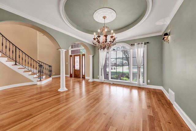 1062 Center Ridge Rd, Collierville, TN 38017 - entrance foyer featuring arched walkways, decorative columns, wood finished floors, a tray ceiling, and crown molding