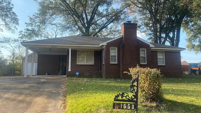 1553 Paullus Ave, Memphis, TN 38127 - view of front of property featuring concrete driveway, a chimney, a front yard, and brick siding