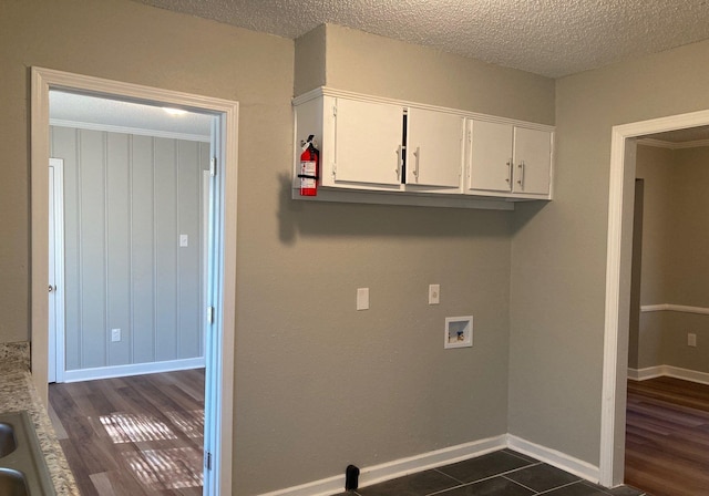 1553 Paullus Ave, Memphis, TN 38127 - washroom featuring cabinet space, washer hookup, a textured ceiling, and dark wood-style floors