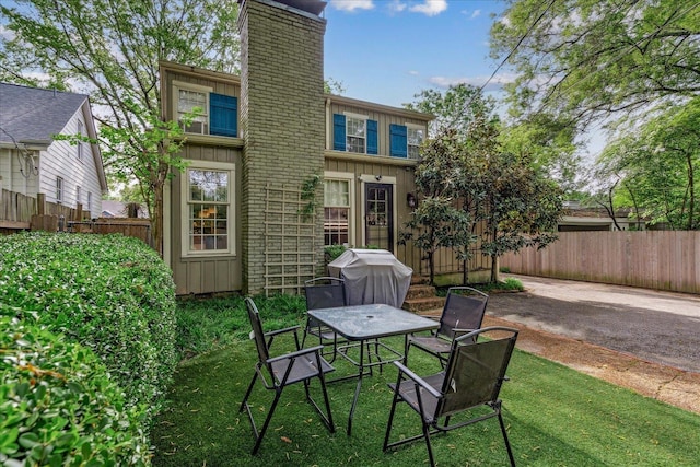 149 Palisade St, Memphis, TN 38111 - rear view of house with a chimney, board and batten siding, and a patio