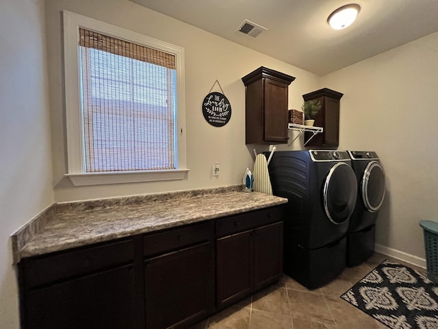 8334 Stonecrest Dr W, Olive Branch, MS 38654 - laundry area featuring washer and clothes dryer, cabinet space, and light tile patterned flooring