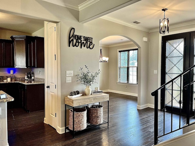 8334 Stonecrest Dr W, Olive Branch, MS 38654 - foyer with dark wood-style floors, a chandelier, arched walkways, and ornamental molding