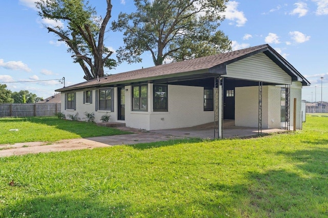1169 Dovecrest Rd, Memphis, TN 38134 - view of front of house with brick siding, a patio area, roof with shingles, and an attached carport