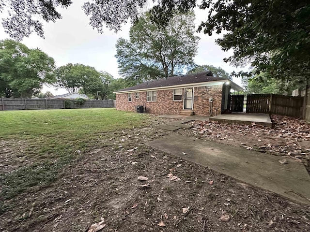 1289 Heathcliff Dr, Memphis, TN 38134 - back of house with a patio, brick siding, and a fenced backyard