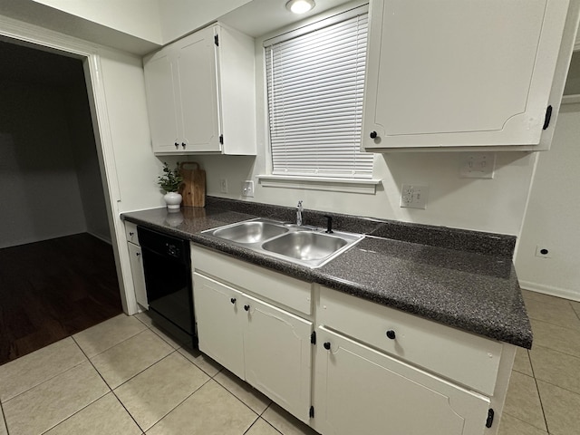 1289 Heathcliff Dr, Memphis, TN 38134 - kitchen with black dishwasher, light tile patterned floors, dark countertops, and white cabinets