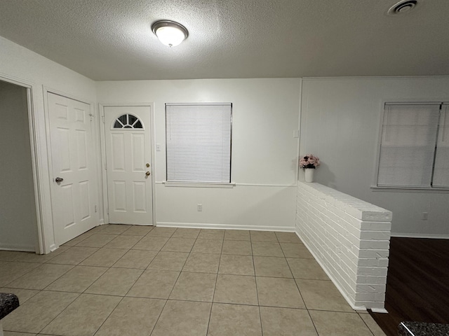 1289 Heathcliff Dr, Memphis, TN 38134 - entryway with a textured ceiling and light tile patterned floors