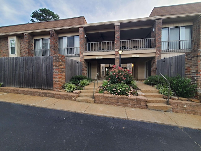 6615 Poplar Ave Unit 1, Germantown, TN 38138 - view of front of home featuring a balcony, brick siding, and a ceiling fan