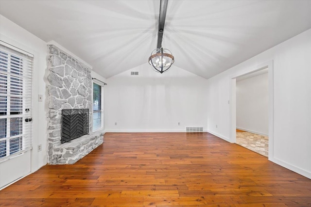 366 Casca Cv, Collierville, TN 38017 - unfurnished living room featuring lofted ceiling, wood finished floors, a chandelier, and a fireplace