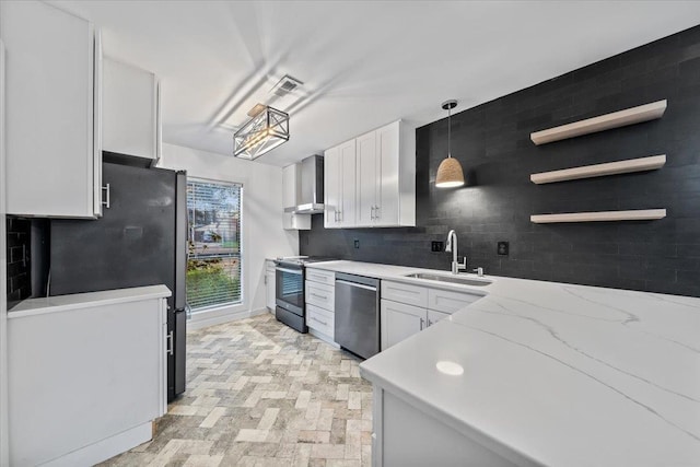 366 Casca Cv, Collierville, TN 38017 - kitchen featuring appliances with stainless steel finishes, wall chimney range hood, decorative backsplash, white cabinets, and hanging light fixtures