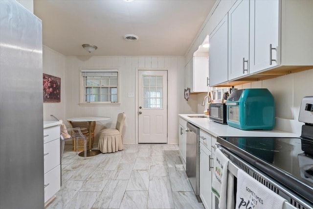 4947 Dee Rd, Memphis, TN 38117 - kitchen with stainless steel appliances, light countertops, light marble finish flooring, and white cabinetry