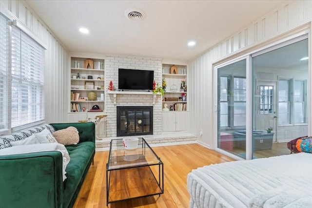 4947 Dee Rd, Memphis, TN 38117 - living area featuring wood finished floors, a fireplace, and built in shelves