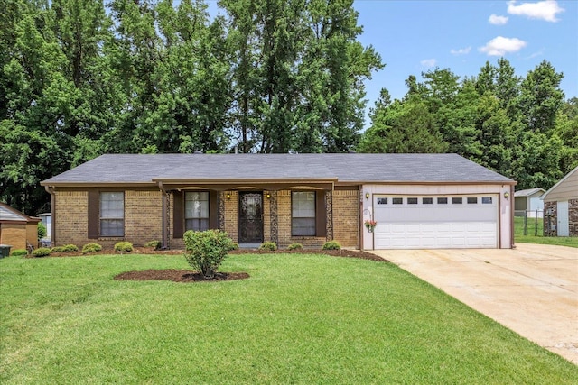 2826 Whitney Ave, Memphis, TN 38127 - ranch-style house with brick siding, concrete driveway, an attached garage, and a front lawn