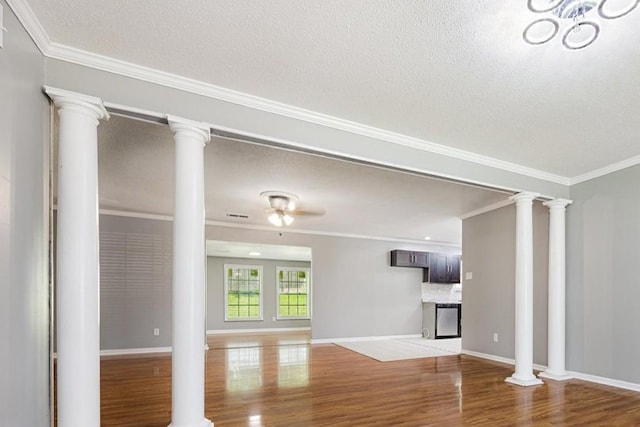 2826 Whitney Ave, Memphis, TN 38127 - unfurnished living room with a textured ceiling, crown molding, and wood finished floors