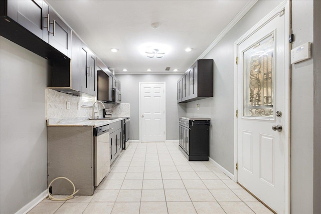 2826 Whitney Ave, Memphis, TN 38127 - kitchen featuring stainless steel dishwasher, light countertops, ornamental molding, backsplash, and light tile patterned flooring