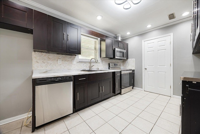 2826 Whitney Ave, Memphis, TN 38127 - kitchen with appliances with stainless steel finishes, light countertops, backsplash, ornamental molding, and recessed lighting
