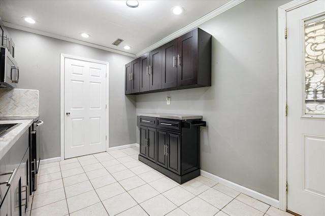2826 Whitney Ave, Memphis, TN 38127 - laundry room with crown molding, light tile patterned floors, and recessed lighting