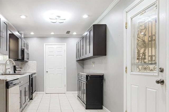 2826 Whitney Ave, Memphis, TN 38127 - kitchen with stainless steel appliances, light countertops, light tile patterned flooring, decorative backsplash, and recessed lighting