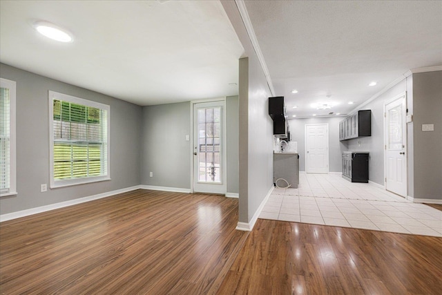 2826 Whitney Ave, Memphis, TN 38127 - unfurnished living room with ornamental molding and light wood-style flooring