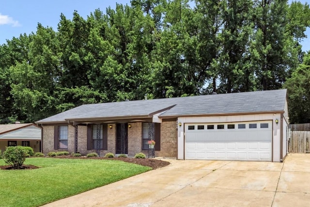 2826 Whitney Ave, Memphis, TN 38127 - view of front of house with driveway, an attached garage, and brick siding