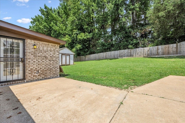 2826 Whitney Ave, Memphis, TN 38127 - fenced backyard featuring a patio and a storage unit