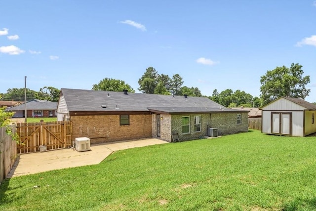 2826 Whitney Ave, Memphis, TN 38127 - rear view of property with a patio area, a fenced backyard, a storage unit, brick siding, and a gate