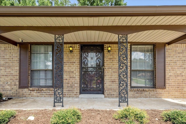 2826 Whitney Ave, Memphis, TN 38127 - view of exterior entry featuring brick siding, a surveillance system, and a porch