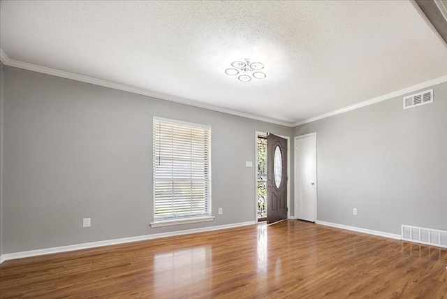 2826 Whitney Ave, Memphis, TN 38127 - entrance foyer with wood finished floors, a textured ceiling, and crown molding
