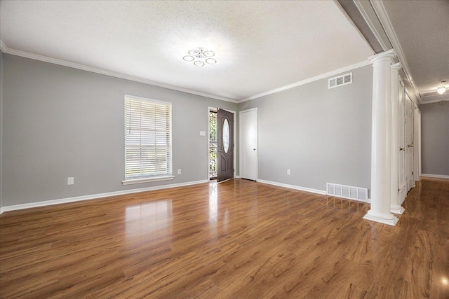 2826 Whitney Ave, Memphis, TN 38127 - spare room featuring ornate columns, crown molding, wood finished floors, and a textured ceiling