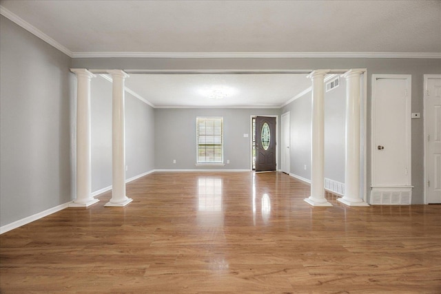 2826 Whitney Ave, Memphis, TN 38127 - unfurnished living room featuring light wood-type flooring, decorative columns, and ornamental molding