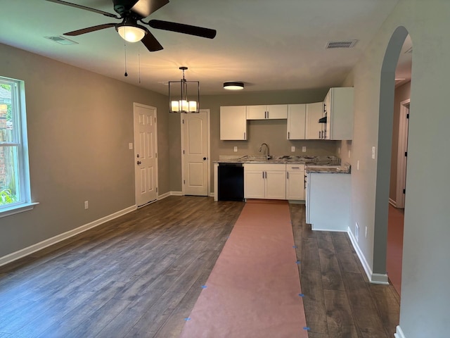 3758 Longfellow Rd, Memphis, TN 38108 - kitchen with black dishwasher, ceiling fan, dark wood-style flooring, and white cabinets