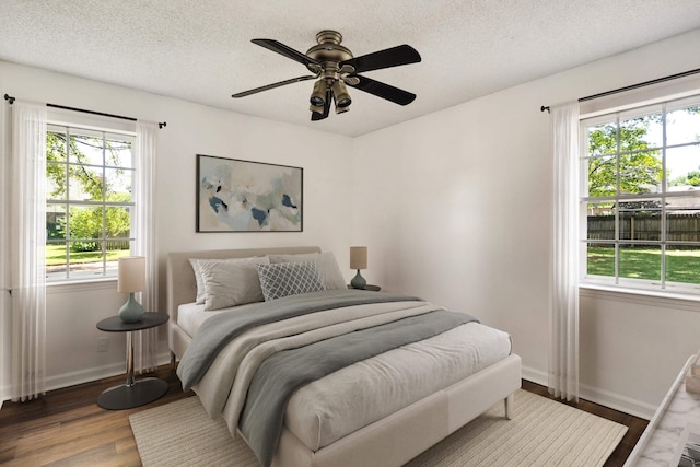 1149 Abbeville St, Collierville, TN 38017 - bedroom with multiple windows, wood finished floors, a textured ceiling, and a ceiling fan