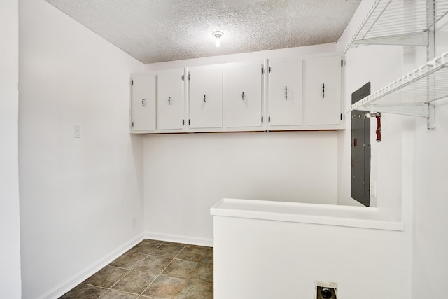 1149 Abbeville St, Collierville, TN 38017 - laundry room featuring cabinet space, a textured ceiling, electric dryer hookup, and electric panel