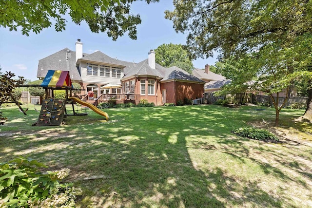 2912 Carnton Dr, Germantown, TN 38138 - rear view of house featuring a playground, brick siding, and a chimney