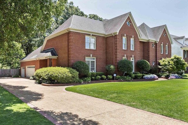 2912 Carnton Dr, Germantown, TN 38138 - view of front facade featuring brick siding, a shingled roof, an attached garage, a front lawn, and driveway