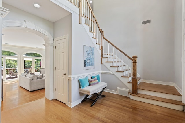 2912 Carnton Dr, Germantown, TN 38138 - stairway featuring wood finished floors, arched walkways, a high ceiling, and decorative columns