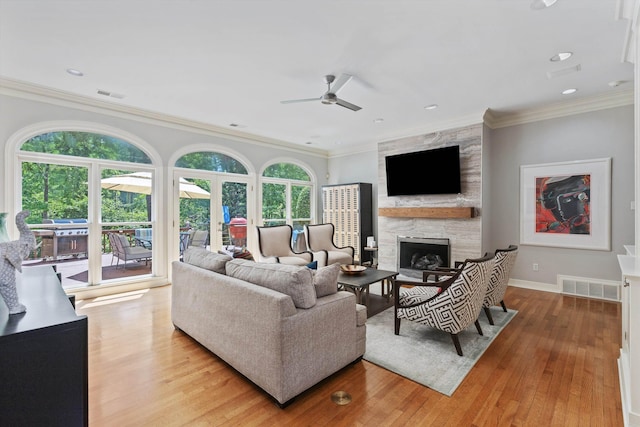 2912 Carnton Dr, Germantown, TN 38138 - living area featuring a ceiling fan, a large fireplace, light wood-style flooring, crown molding, and recessed lighting