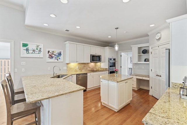 2912 Carnton Dr, Germantown, TN 38138 - kitchen with stainless steel appliances, a peninsula, open shelves, light wood-style flooring, and recessed lighting