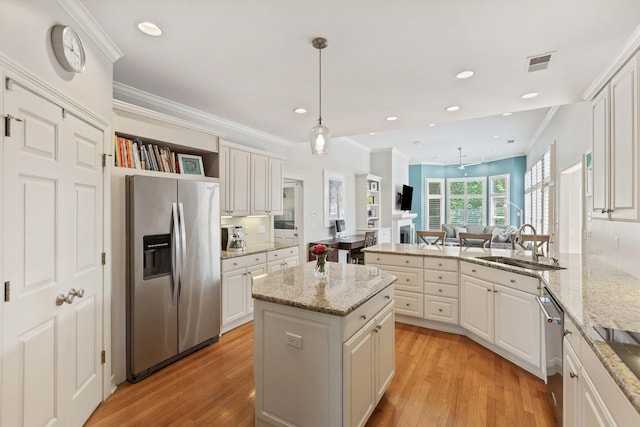 2912 Carnton Dr, Germantown, TN 38138 - kitchen featuring appliances with stainless steel finishes, a peninsula, light wood finished floors, a center island, and recessed lighting