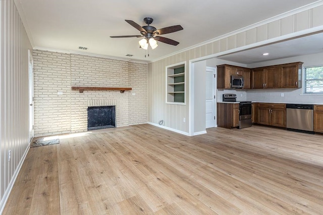 5153 Helene Rd, Memphis, TN 38117 - unfurnished living room with a ceiling fan, crown molding, built in features, light wood-style floors, and a fireplace