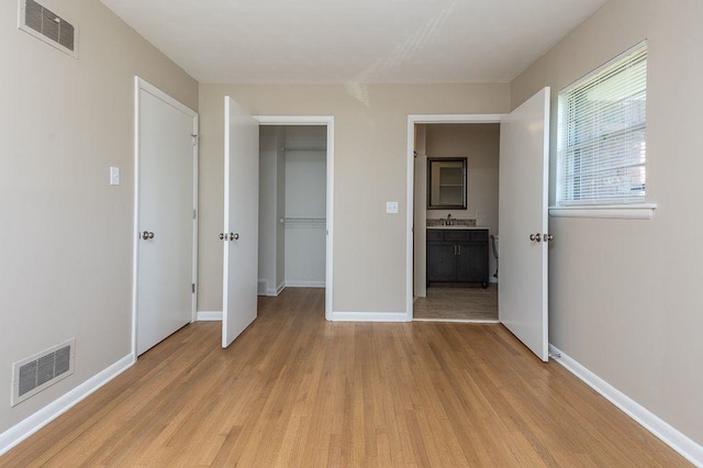 5153 Helene Rd, Memphis, TN 38117 - unfurnished bedroom featuring light wood-style floors, a spacious closet, and a closet